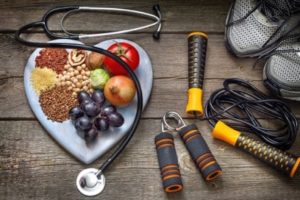 symbols of ways ot prevent vascular disease: healthy foods and exercise